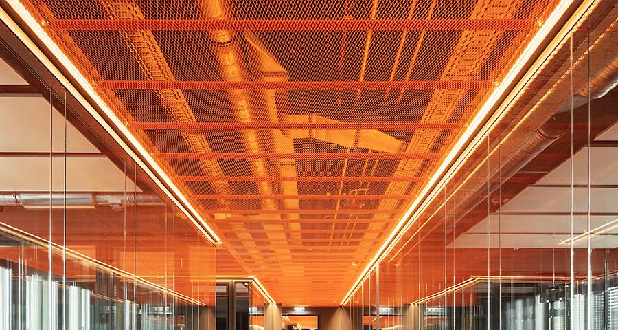 Expanded mesh ceiling installed on top of office corridor