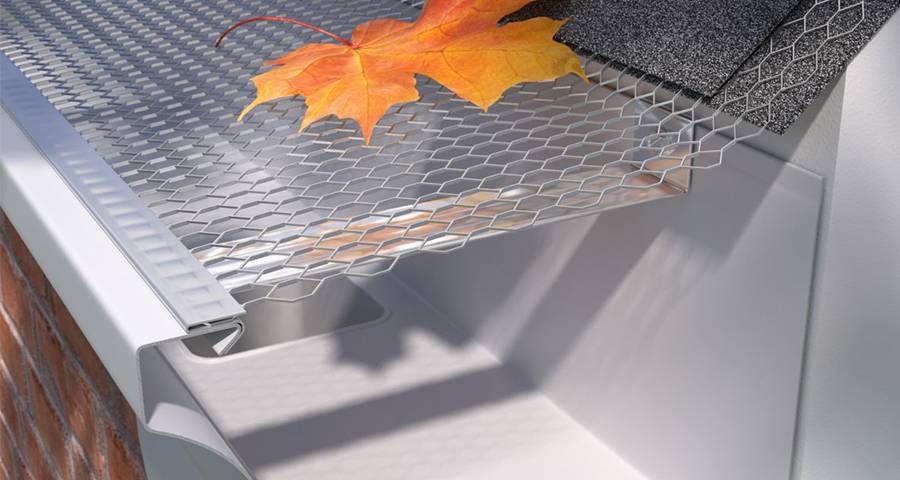 A leaf falls on the silver gray hexagon hole expanded metal gutter guard cover