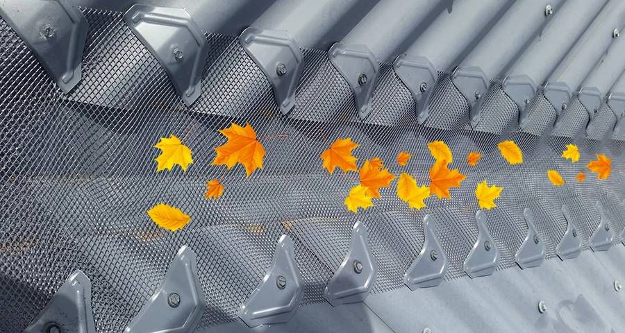 Fallen leaves are blocked outside the silver gray expanded metal gutter guard cover