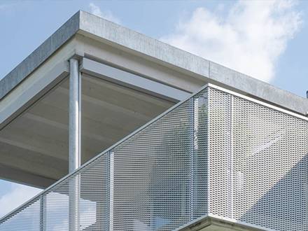 White PVC coating expanded metal railings are installed around the balconies