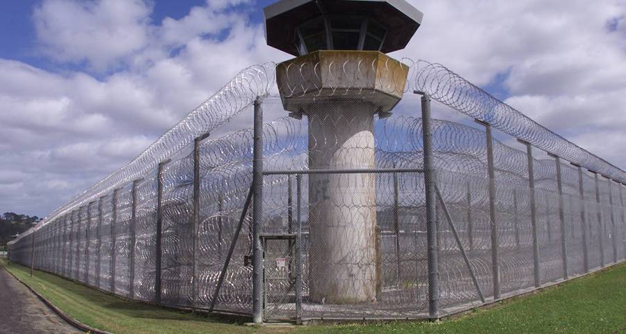 Concertina wire installed on top and inside of chain link fence for prison security protection