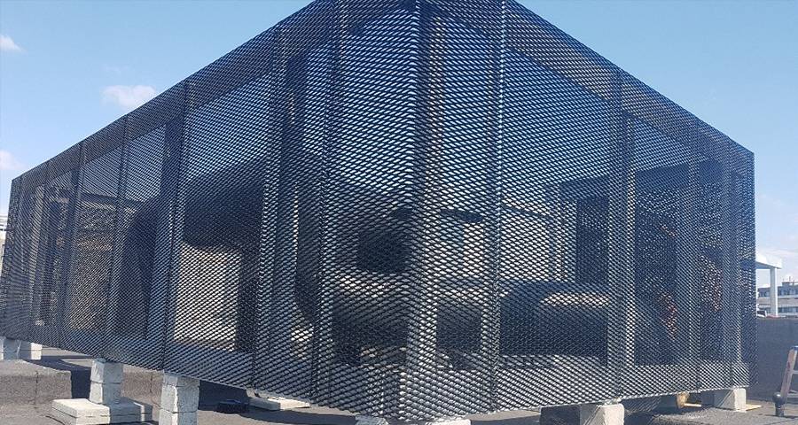 A worker is plastering a wall to which expanded metal lath has been fixed