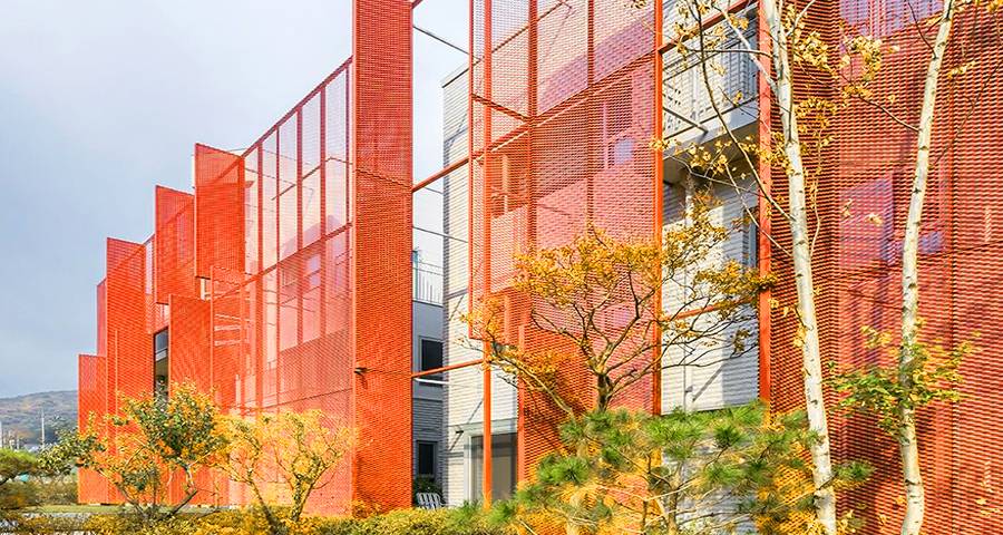 Orange Expanded metal panels is used for shading in residential