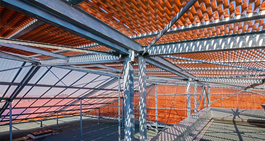 Orange Expanded metal panels is used for shading on stadium
