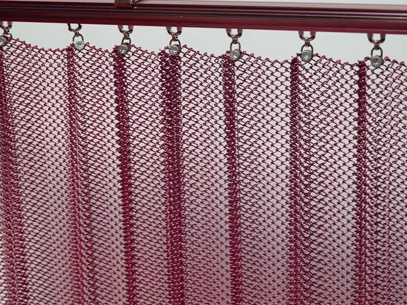 Metal coil drapery curtain installed on track