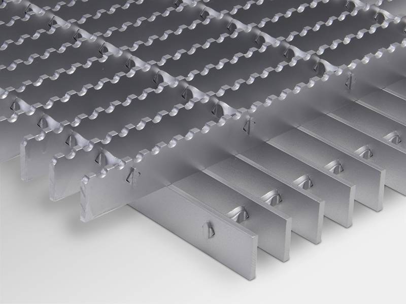 A serrated surface steel grating placed on a smooth surface steel grating